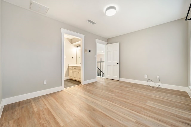 unfurnished bedroom featuring visible vents, light wood finished floors, and baseboards