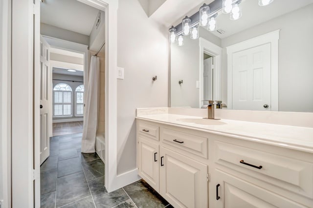 full bathroom with vanity, baseboards, and a shower with shower curtain