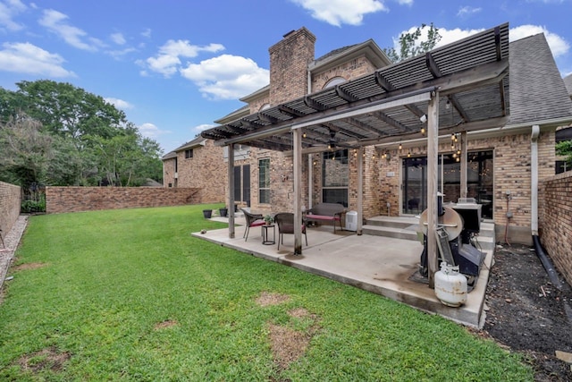 back of house featuring a lawn, a patio area, brick siding, a fenced backyard, and a pergola