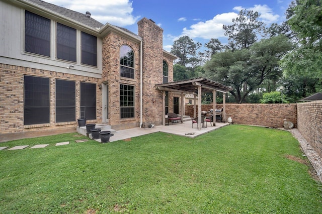 rear view of property with a patio area, brick siding, a fenced backyard, a yard, and a pergola