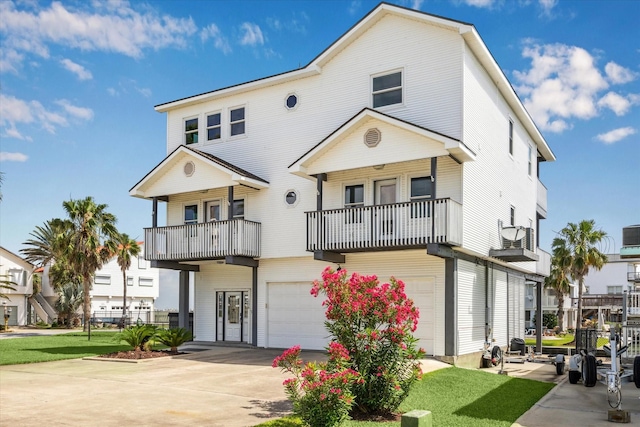 138 Isles End Rd, Tiki Island, TX 77554 - view of front of property featuring a balcony, a garage, and concrete driveway