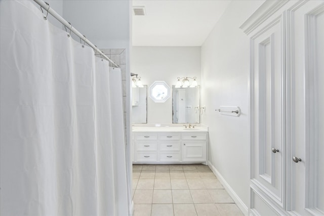 138 Isles End Rd, Tiki Island, TX 77554 - bathroom with tile patterned floors, vanity, and baseboards
