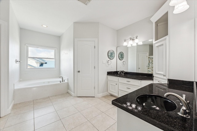 138 Isles End Rd, Tiki Island, TX 77554 - bathroom featuring tile patterned flooring, a bath, vanity, and baseboards
