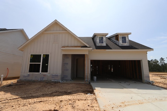 18623 Rumba Ct, Conroe, TX 77302 - view of front facade with a garage, driveway, board and batten siding, and roof with shingles