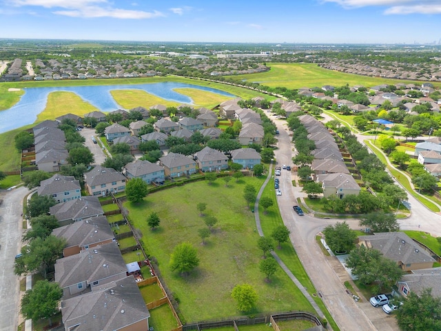birds eye view of property featuring a water view and a residential view