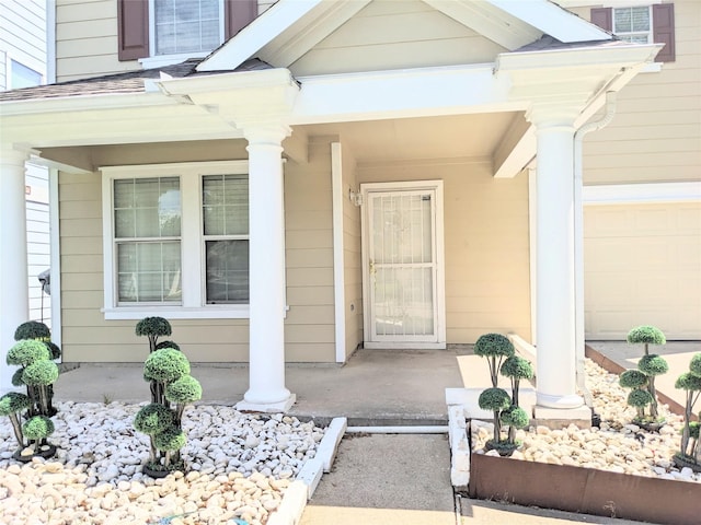 view of exterior entry with a porch