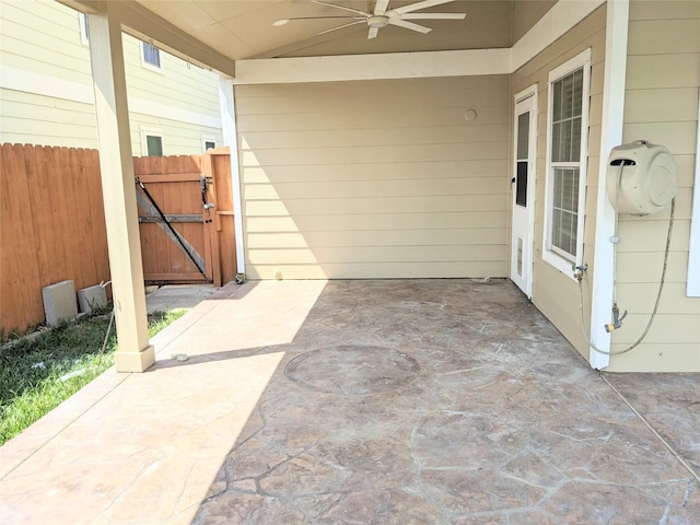 view of patio featuring a gate, ceiling fan, and fence