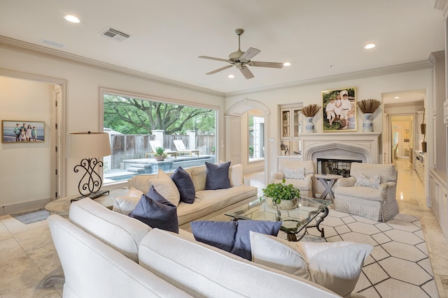 living room featuring a glass covered fireplace, recessed lighting, and visible vents