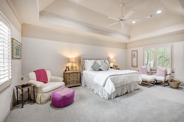 carpeted bedroom with baseboards, a tray ceiling, recessed lighting, and visible vents