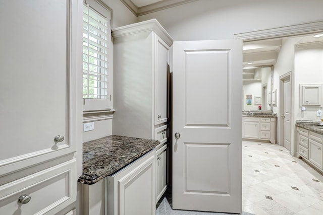 bathroom with ornamental molding and vanity