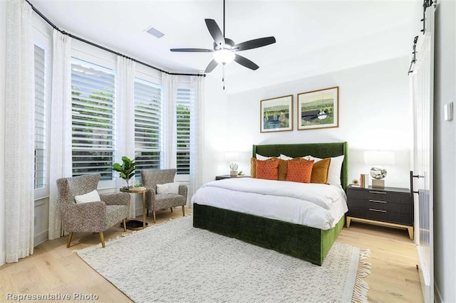 16427 Cat Ct, Conroe, TX 77302 - bedroom with a ceiling fan, light wood finished floors, and visible vents
