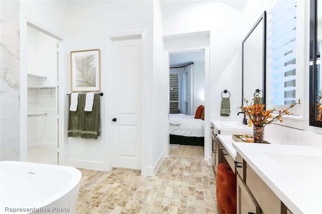 16427 Cat Ct, Conroe, TX 77302 - full bathroom with double vanity, a sink, ensuite bath, and a soaking tub