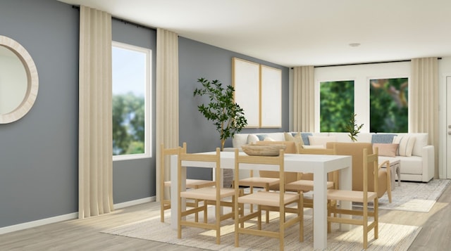 dining space with light wood-style floors and baseboards