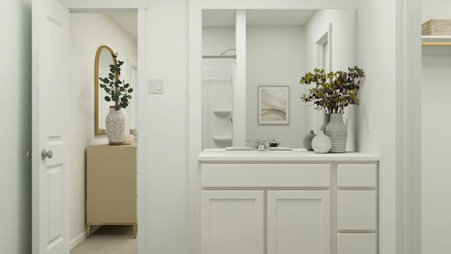 bathroom with vanity and a shower