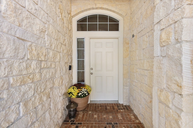 property entrance featuring stone siding
