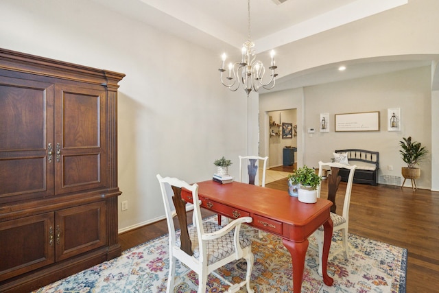 office with arched walkways, baseboards, a notable chandelier, and wood finished floors