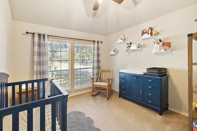 bedroom with light colored carpet, a ceiling fan, and baseboards