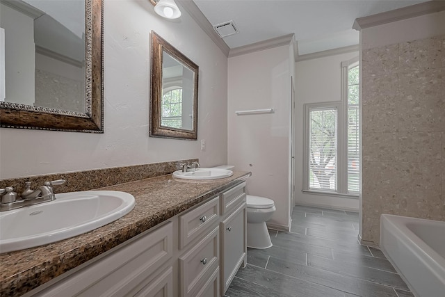 10310 Sable Trail Ln, Houston, TX 77064 - full bath with toilet, plenty of natural light, a tub to relax in, crown molding, and double vanity