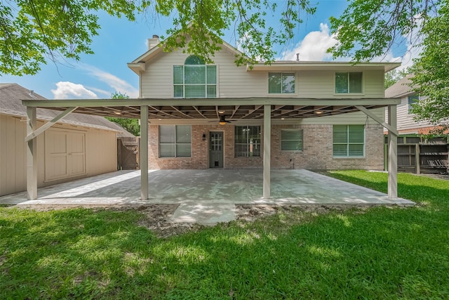 10310 Sable Trail Ln, Houston, TX 77064 - rear view of property featuring ceiling fan, a storage unit, brick siding, a patio area, and an outbuilding