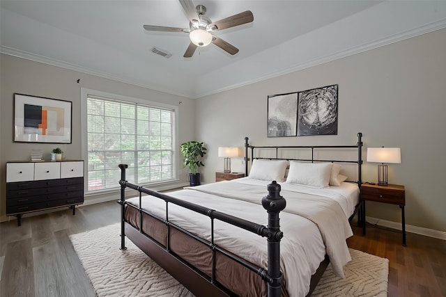 10310 Sable Trail Ln, Houston, TX 77064 - bedroom featuring wood finished floors, a tray ceiling, ceiling fan, baseboards, and ornamental molding