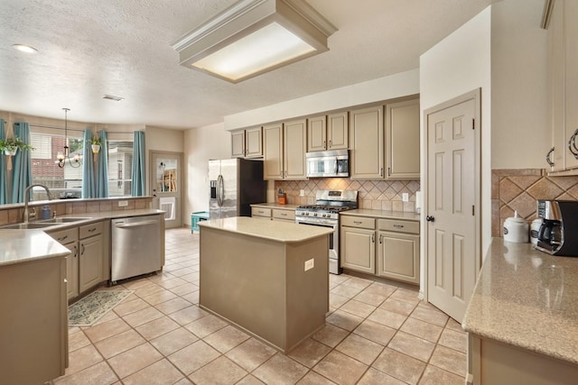 kitchen featuring a sink, a chandelier, a center island, stainless steel appliances, and tasteful backsplash