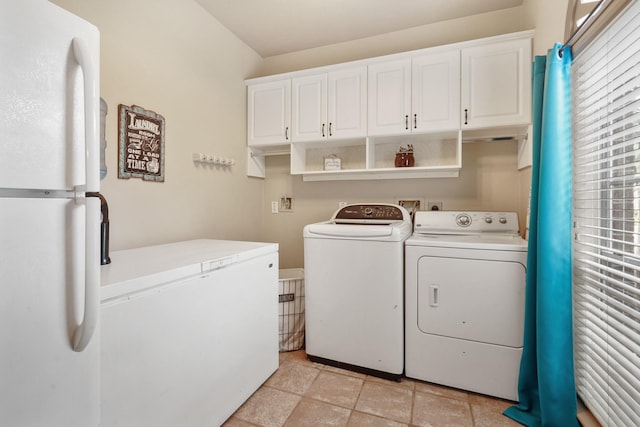 clothes washing area featuring cabinet space and independent washer and dryer