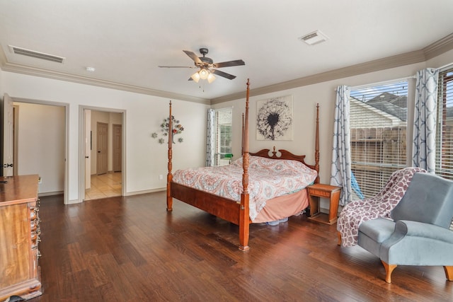 bedroom with crown molding, baseboards, wood finished floors, and visible vents