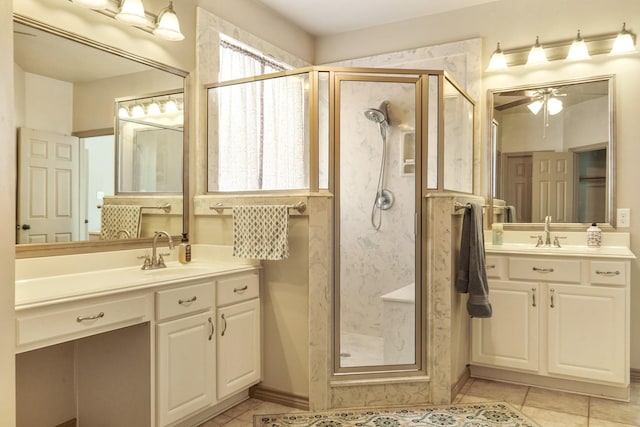bathroom with a shower stall, a sink, and tile patterned flooring