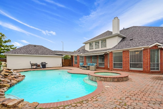 view of swimming pool featuring fence, a pool with connected hot tub, an outdoor hangout area, a patio area, and a grill
