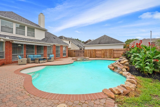 view of pool with a patio, a pool with connected hot tub, outdoor lounge area, and a fenced backyard