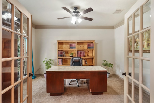 carpeted office space featuring french doors, ornamental molding, ceiling fan, and visible vents