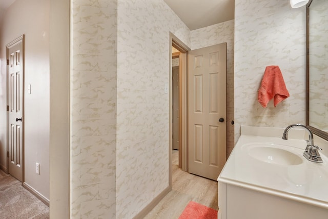 bathroom with vanity and wood finished floors