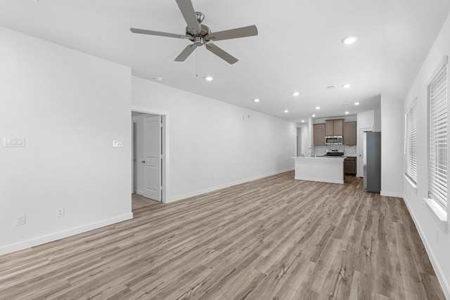 unfurnished living room with recessed lighting, ceiling fan, baseboards, and light wood-type flooring