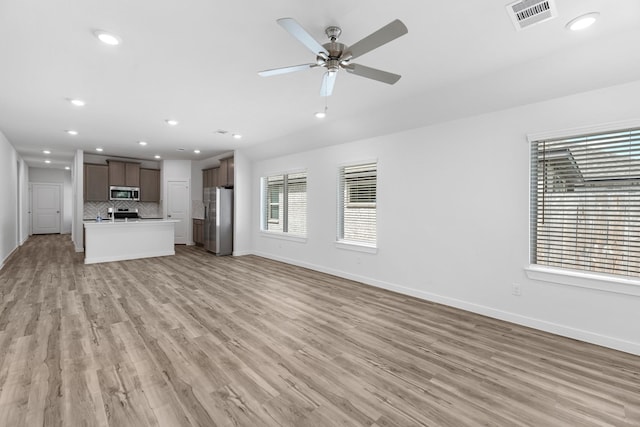 unfurnished living room with recessed lighting, baseboards, visible vents, and light wood-type flooring