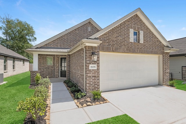 view of front facade with a garage, concrete driveway, a front lawn, and brick siding