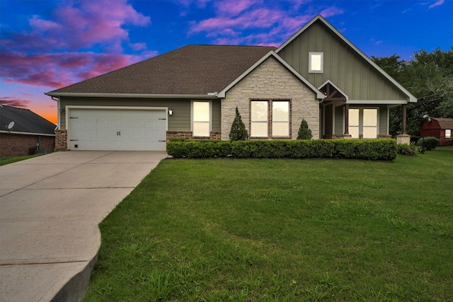 traditional home featuring board and batten siding, driveway, brick siding, a front lawn, and an attached garage