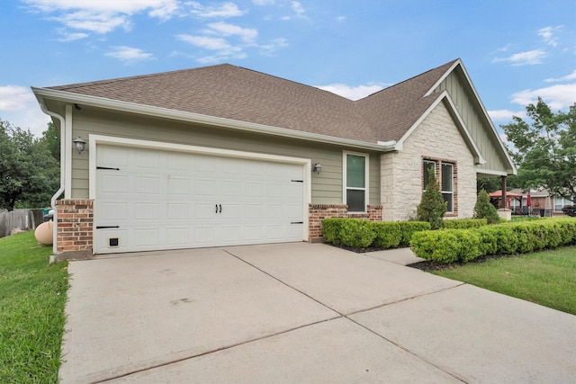 view of front of home with brick siding, a shingled roof, board and batten siding, an attached garage, and driveway