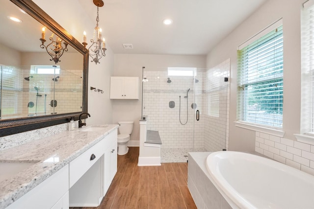 full bath with wood finished floors, a stall shower, visible vents, and toilet