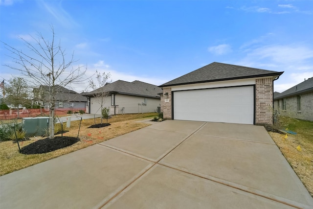 1650 Portia Ln, Conroe, TX 77301 - view of front of property featuring a detached garage, brick siding, and a shingled roof
