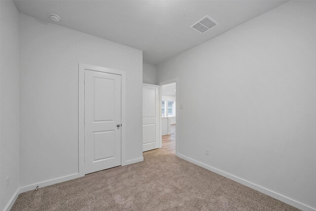 1650 Portia Ln, Conroe, TX 77301 - unfurnished bedroom with carpet floors, baseboards, and visible vents