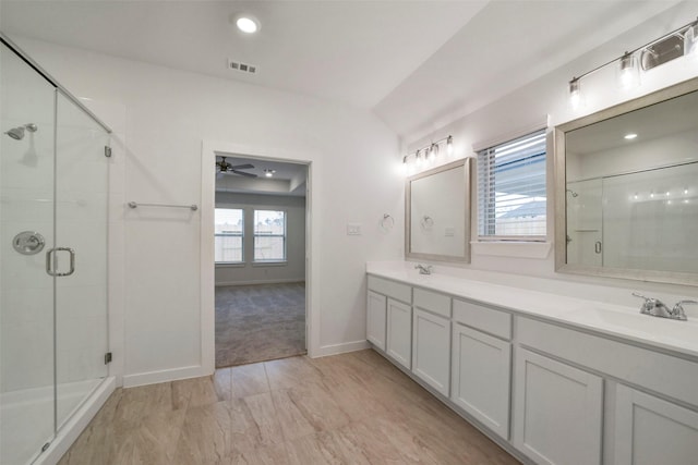1730 Portia Ln, Conroe, TX 77301 - bathroom with visible vents, double vanity, ceiling fan, a shower stall, and a sink