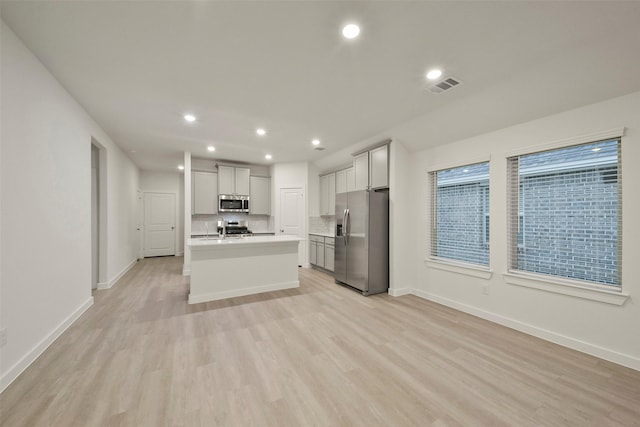 1710 Portia Ln, Conroe, TX 77301 - kitchen featuring visible vents, recessed lighting, light wood-style floors, and appliances with stainless steel finishes