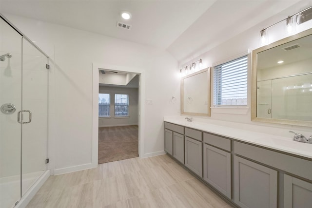 1710 Portia Ln, Conroe, TX 77301 - full bathroom with visible vents, double vanity, a sink, and a shower stall