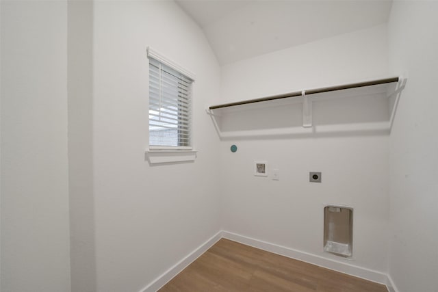 1710 Portia Ln, Conroe, TX 77301 - washroom with laundry area, washer hookup, baseboards, wood finished floors, and hookup for an electric dryer