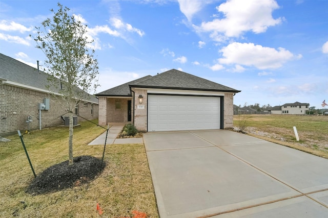 1710 Portia Ln, Conroe, TX 77301 - ranch-style house featuring a garage, a front yard, driveway, and brick siding