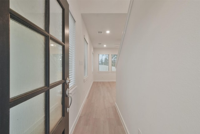 hallway featuring recessed lighting, baseboards, visible vents, and light wood-style flooring