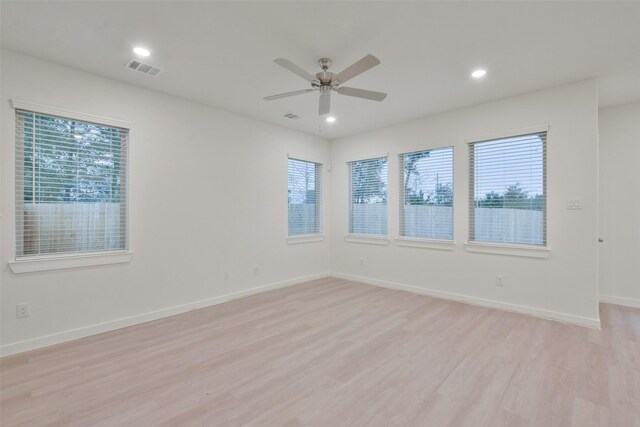 empty room with visible vents, a ceiling fan, light wood finished floors, and recessed lighting