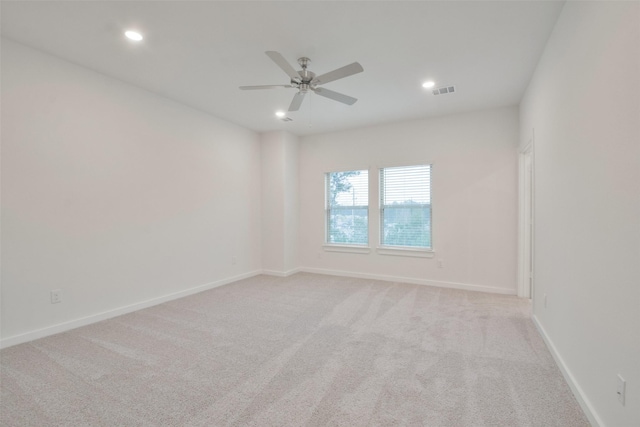unfurnished room with a ceiling fan, visible vents, baseboards, carpet flooring, and recessed lighting