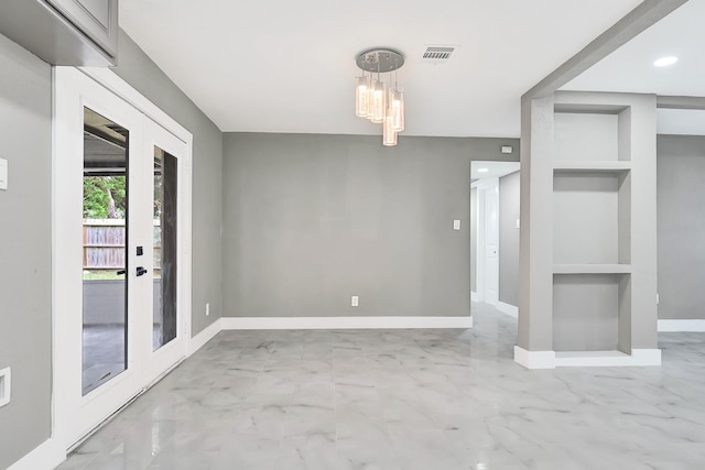 unfurnished dining area with visible vents, marble finish floor, baseboards, built in shelves, and a notable chandelier
