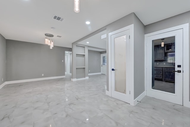 interior space featuring visible vents, built in shelves, baseboards, marble finish floor, and recessed lighting